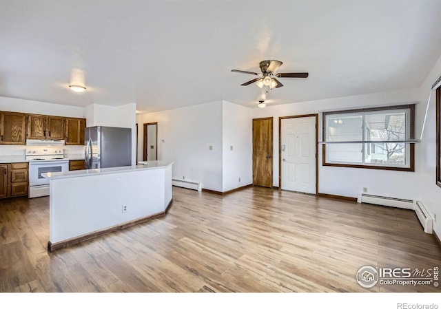 kitchen with ceiling fan, baseboard heating, light hardwood / wood-style flooring, white electric stove, and stainless steel fridge