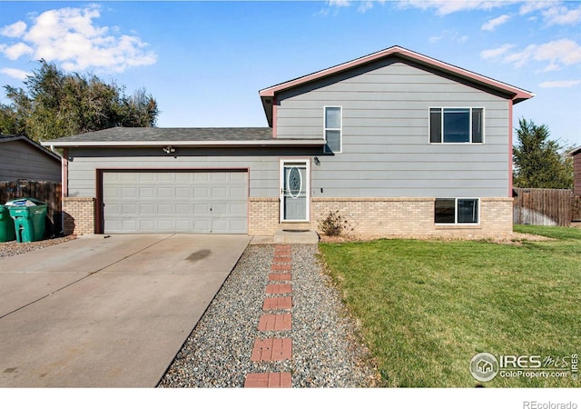 tri-level home with a garage and a front yard