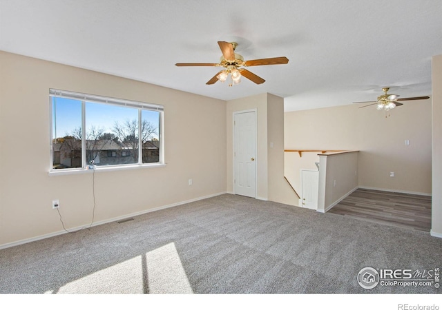 unfurnished room with ceiling fan and carpet