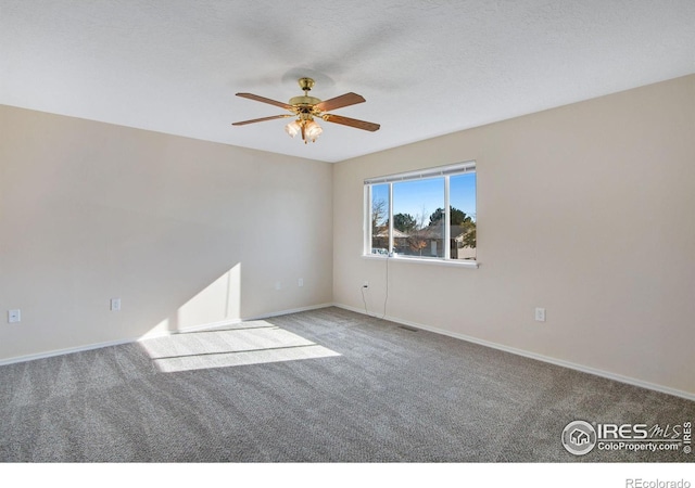 carpeted empty room featuring a textured ceiling and ceiling fan