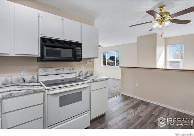 kitchen with plenty of natural light, white cabinetry, and white range with electric cooktop