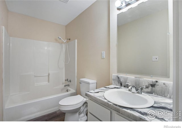 full bathroom with toilet, vanity, wood-type flooring, and bathing tub / shower combination