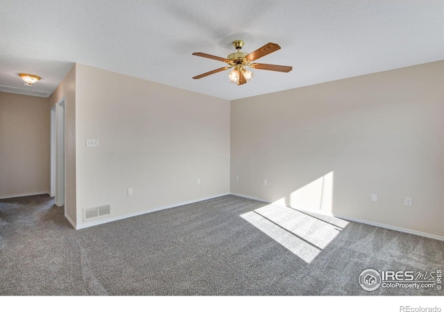 carpeted spare room featuring ceiling fan