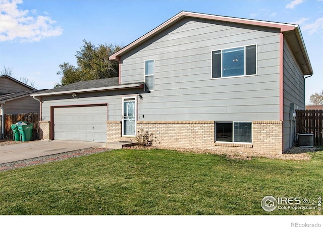 tri-level home featuring a garage and a front yard