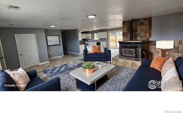18542 County Road 8, Wiggins, CO 80654 - living area featuring baseboards and a textured ceiling