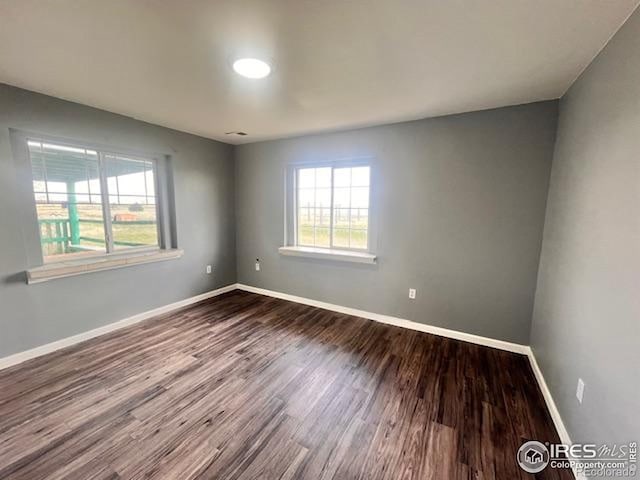 18542 County Road 8, Wiggins, CO 80654 - spare room with dark wood-type flooring and baseboards
