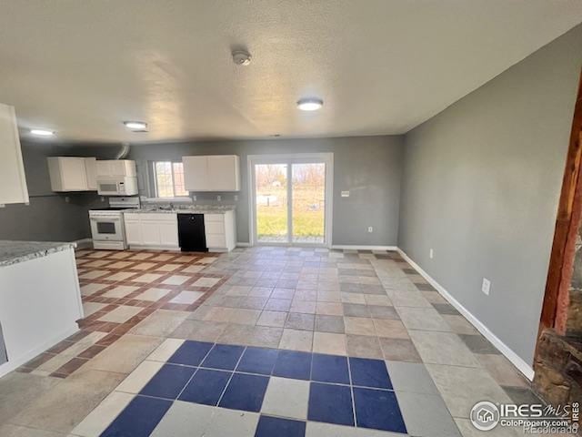 18542 County Road 8, Wiggins, CO 80654 - kitchen featuring white appliances, white cabinets, baseboards, and light stone counters