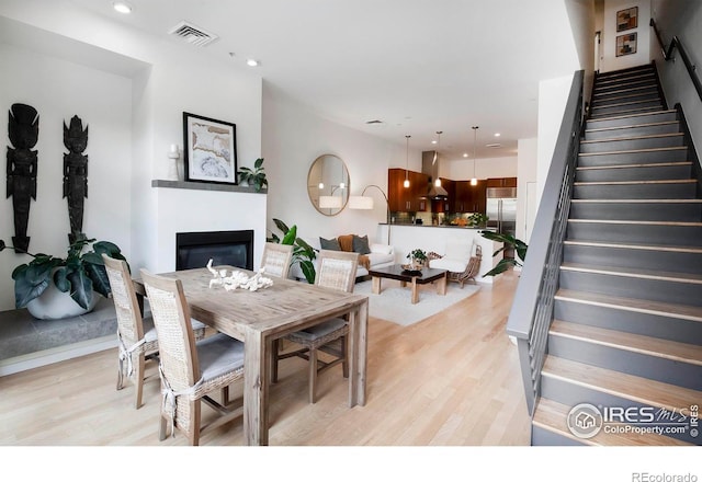 dining space featuring light wood-type flooring