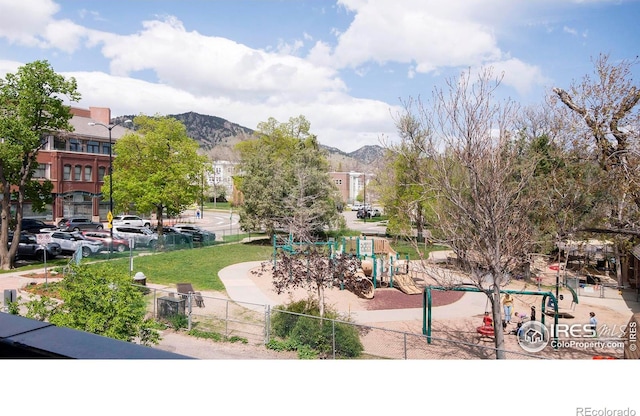 view of home's community featuring a mountain view and a playground