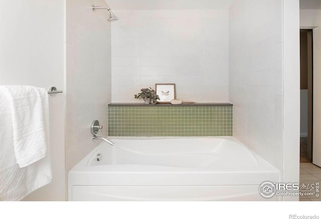 bathroom with a tub and tile patterned floors