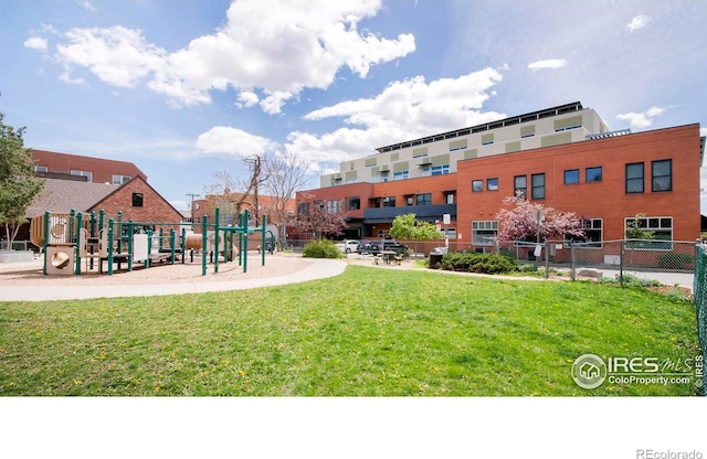 view of community featuring a playground and a yard