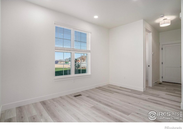 unfurnished room with light hardwood / wood-style flooring