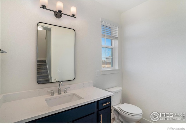 bathroom featuring vanity and toilet