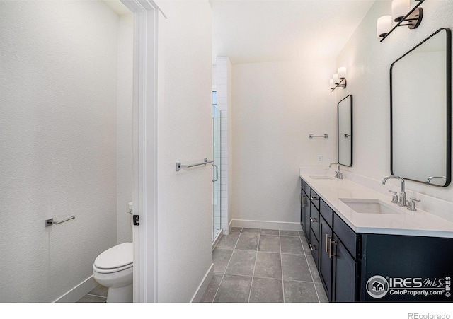 bathroom with vanity, tile patterned floors, and toilet