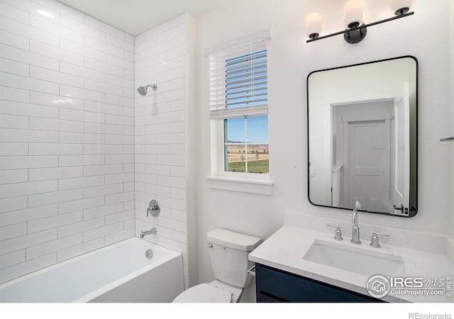 full bathroom featuring tiled shower / bath, toilet, and vanity