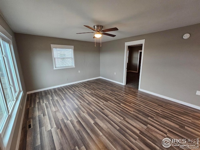 unfurnished room with dark hardwood / wood-style floors and ceiling fan