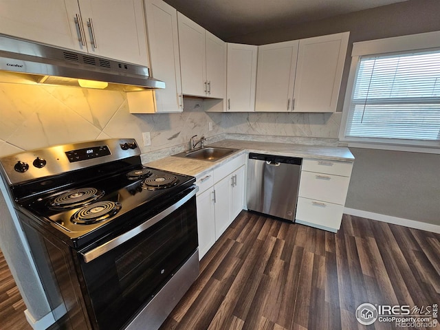 kitchen with sink, white cabinetry, dark wood-type flooring, and appliances with stainless steel finishes