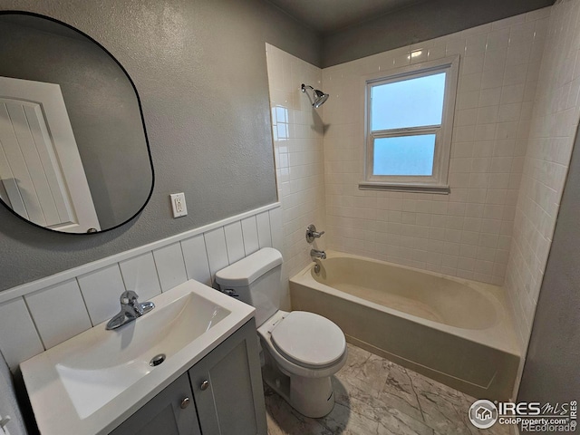 full bathroom with vanity, toilet, and tiled shower / bath