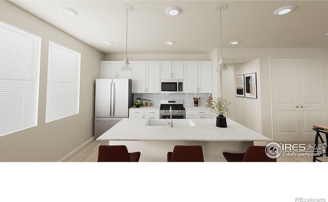 kitchen with stainless steel appliances, hanging light fixtures, decorative backsplash, white cabinets, and a kitchen island with sink