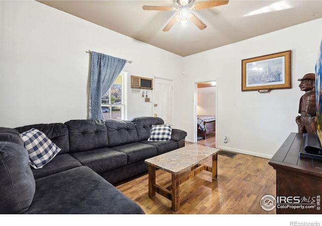 living room with ceiling fan and light hardwood / wood-style flooring