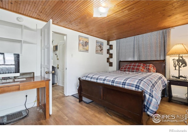 bedroom with wood ceiling and hardwood / wood-style floors