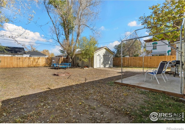 view of yard with an outbuilding and a wooden deck