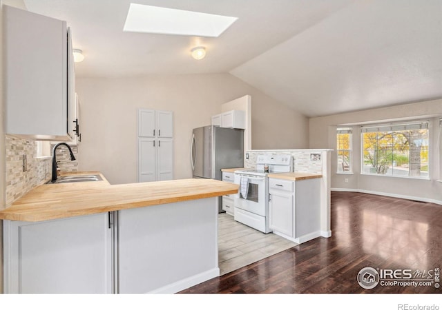 kitchen featuring white range with electric cooktop, kitchen peninsula, hardwood / wood-style flooring, sink, and butcher block countertops