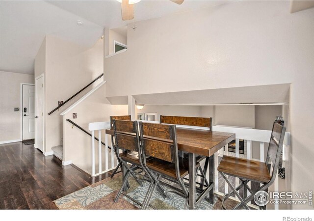 dining space with dark wood-type flooring and ceiling fan