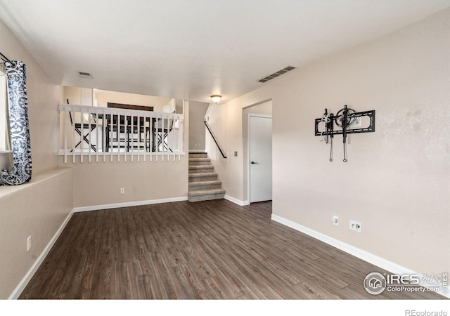 spare room featuring dark wood-type flooring