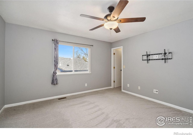 carpeted empty room with ceiling fan