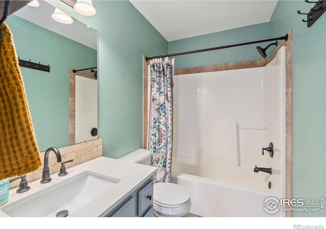 full bathroom with toilet, vanity, and shower / bath combo with shower curtain