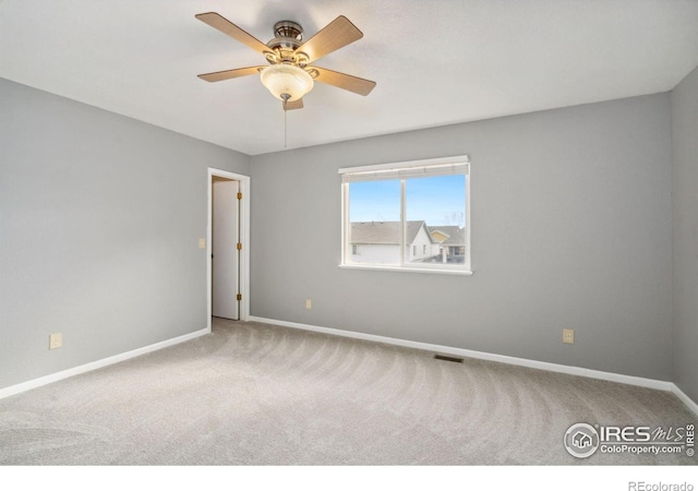 unfurnished room with carpet and ceiling fan