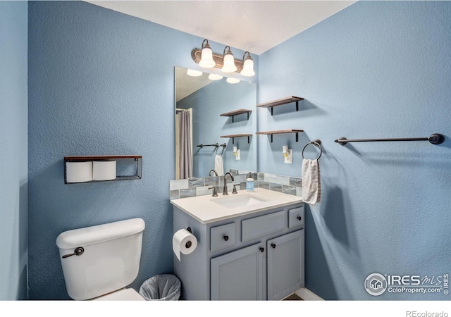 bathroom featuring tasteful backsplash and vanity