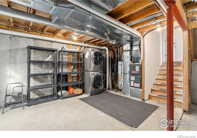 basement with water heater, stacked washer and clothes dryer, and heating unit