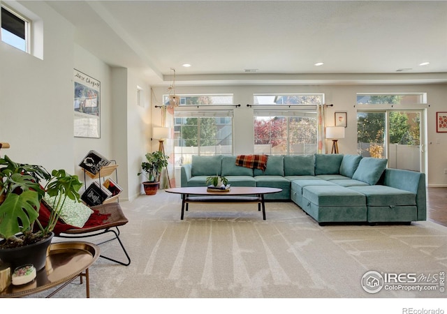 living room featuring plenty of natural light and carpet floors