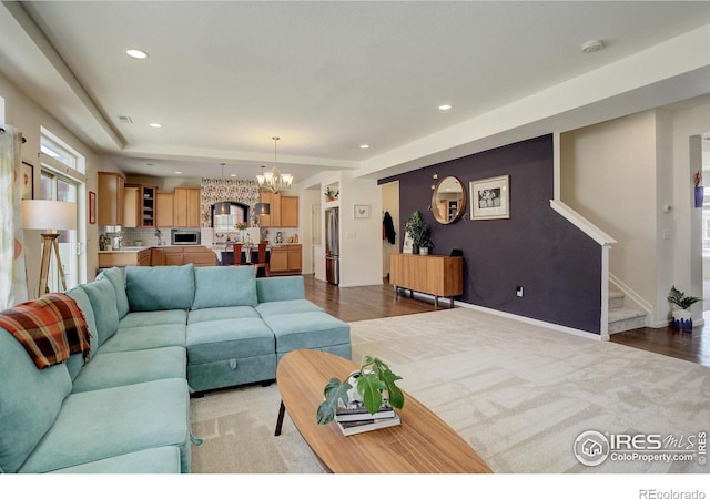 living room with dark hardwood / wood-style flooring and an inviting chandelier