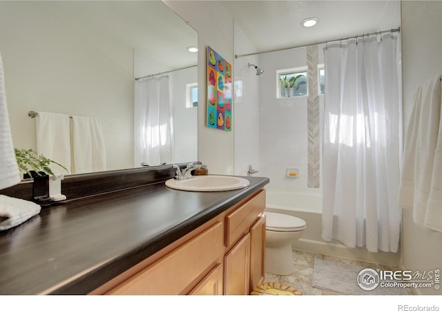 full bathroom featuring shower / tub combo with curtain, vanity, and toilet