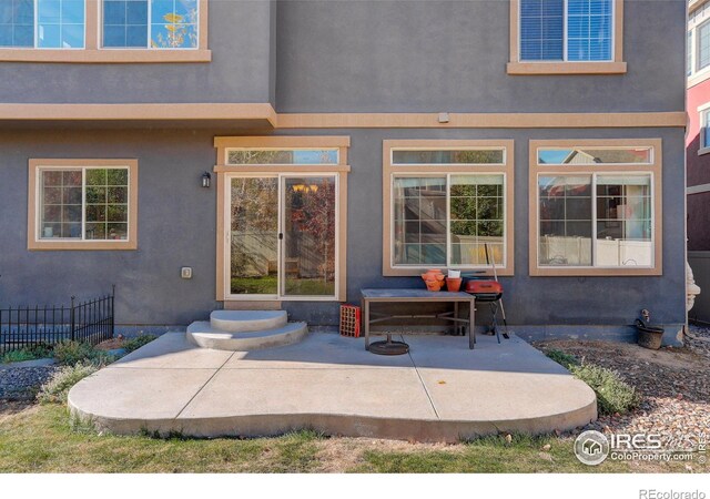 view of exterior entry with a patio