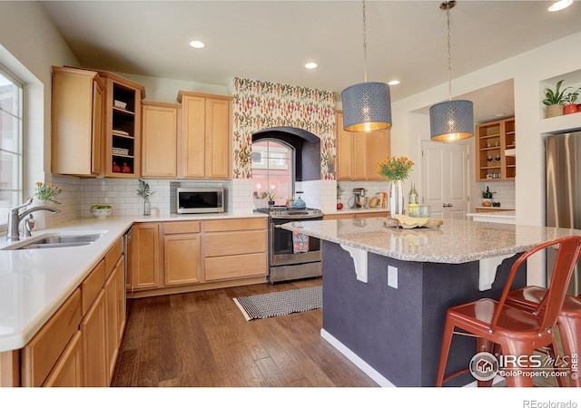 185 Pipit Lake Way, Erie, CO 80516 - kitchen featuring open shelves, appliances with stainless steel finishes, a sink, light brown cabinets, and a breakfast bar area