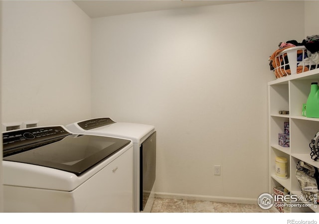 clothes washing area featuring washer and dryer