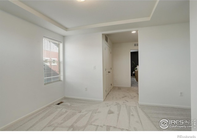 185 Pipit Lake Way, Erie, CO 80516 - carpeted spare room featuring baseboards, a tray ceiling, and recessed lighting
