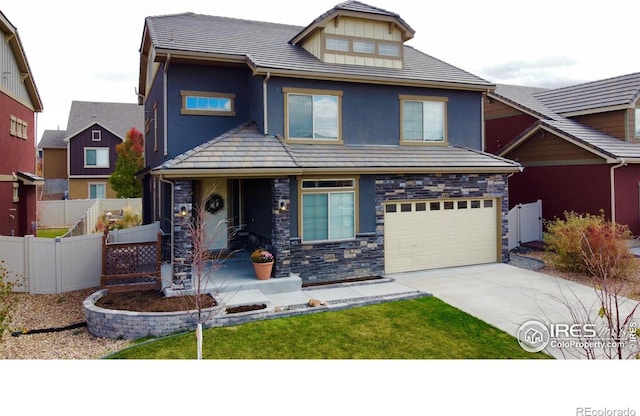 185 Pipit Lake Way, Erie, CO 80516 - view of front of home with concrete driveway, an attached garage, stucco siding, covered porch, and stone siding