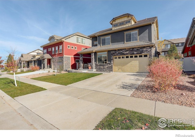 185 Pipit Lake Way, Erie, CO 80516 - view of front of property with stone siding, a garage, concrete driveway, and stucco siding