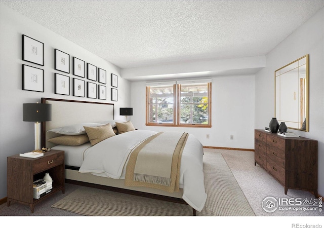 carpeted bedroom featuring a textured ceiling