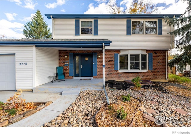 front facade with a garage and a porch