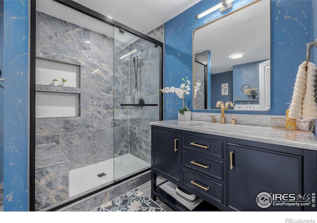 bathroom with walk in shower and vanity