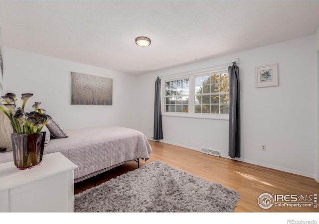 bedroom with hardwood / wood-style floors