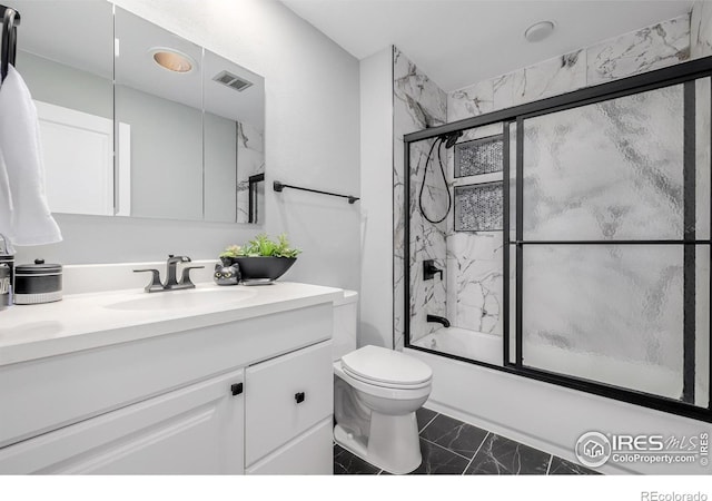 full bathroom featuring toilet, combined bath / shower with glass door, and vanity