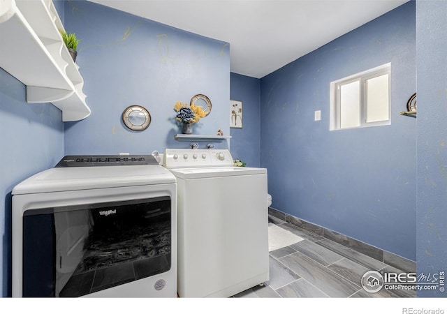 laundry room with washing machine and clothes dryer