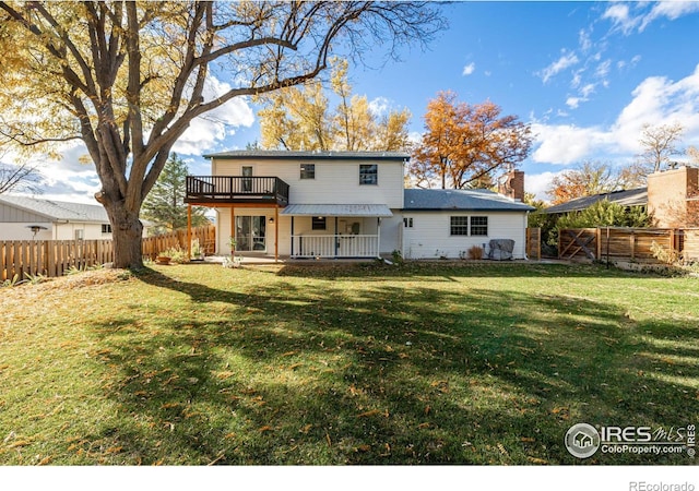 rear view of property featuring a yard